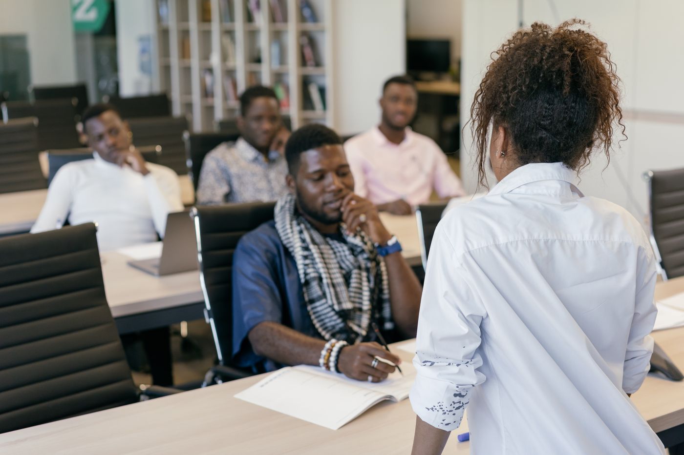 Illustrative stock photo of a training session and interactive discussion in a professional classroom